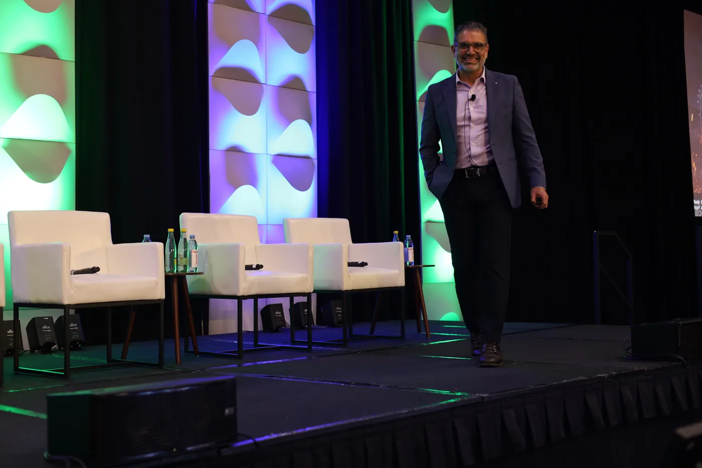 Moudy Elbayadi presenting on stage at an EVOTEK event